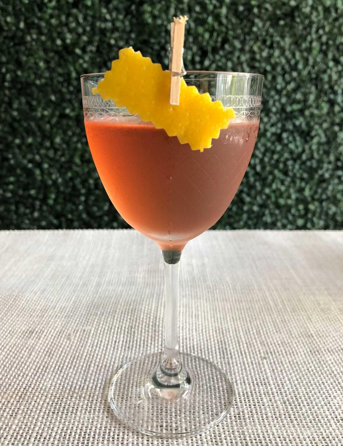 An example of the Dark Side of the Cool, the mixed drink (drink) featuring Comoz Blanc Vermouth de Chambèry, Blume Marillen Apricot Eau-de-Vie, Angostura bitters, and lemon twist; photo by Lee Edwards