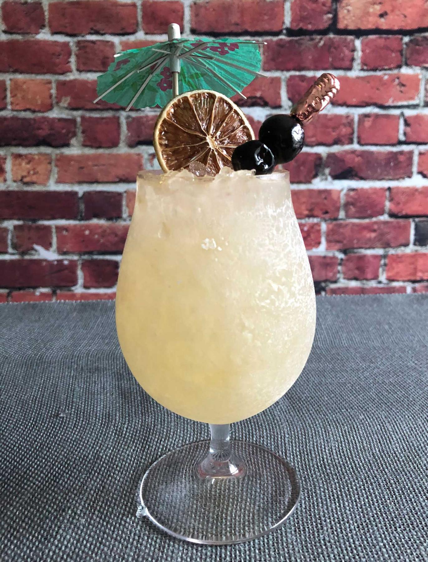 An example of the Commodore Swizzle, the mixed drink (drink), by Zachary Gensicke, The Saturn Room, Tulsa, Oklahoma, featuring Hayman’s Royal Dock Navy Strength Gin, Dolin Génépy le Chamois Liqueur, lime juice, raw sugar syrup, orange bitters, Bittercube Jamaican #2 Bitters, and absinthe; photo by Lee Edwards