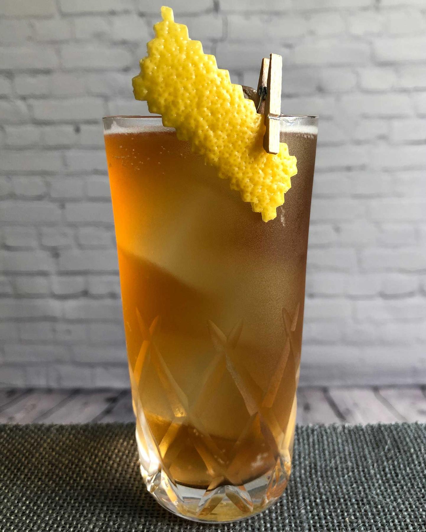 An example of the North Coasts Highball, the mixed drink (drink) featuring soda water, calvados, Mattei Cap Corse Rouge Quinquina, and lemon twist; photo by Lee Edwards