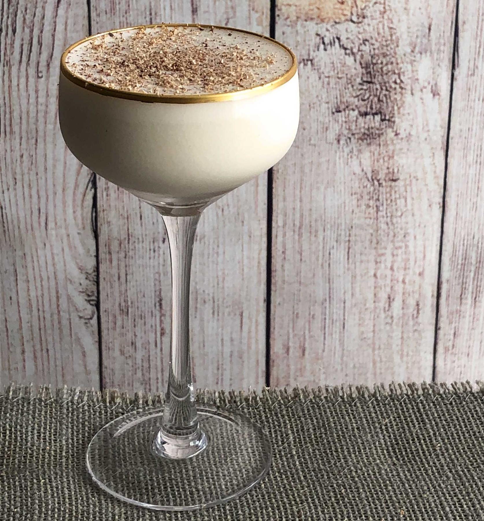 An example of the Barbary Coast, the mixed drink (drink), variation of a drink from the Savoy Cocktail Book, featuring Tresmontaine “tabacal” Rancio, Hayman’s London Dry Gin, crème de cacao (white), cream, and grated nutmeg; photo by Lee Edwards