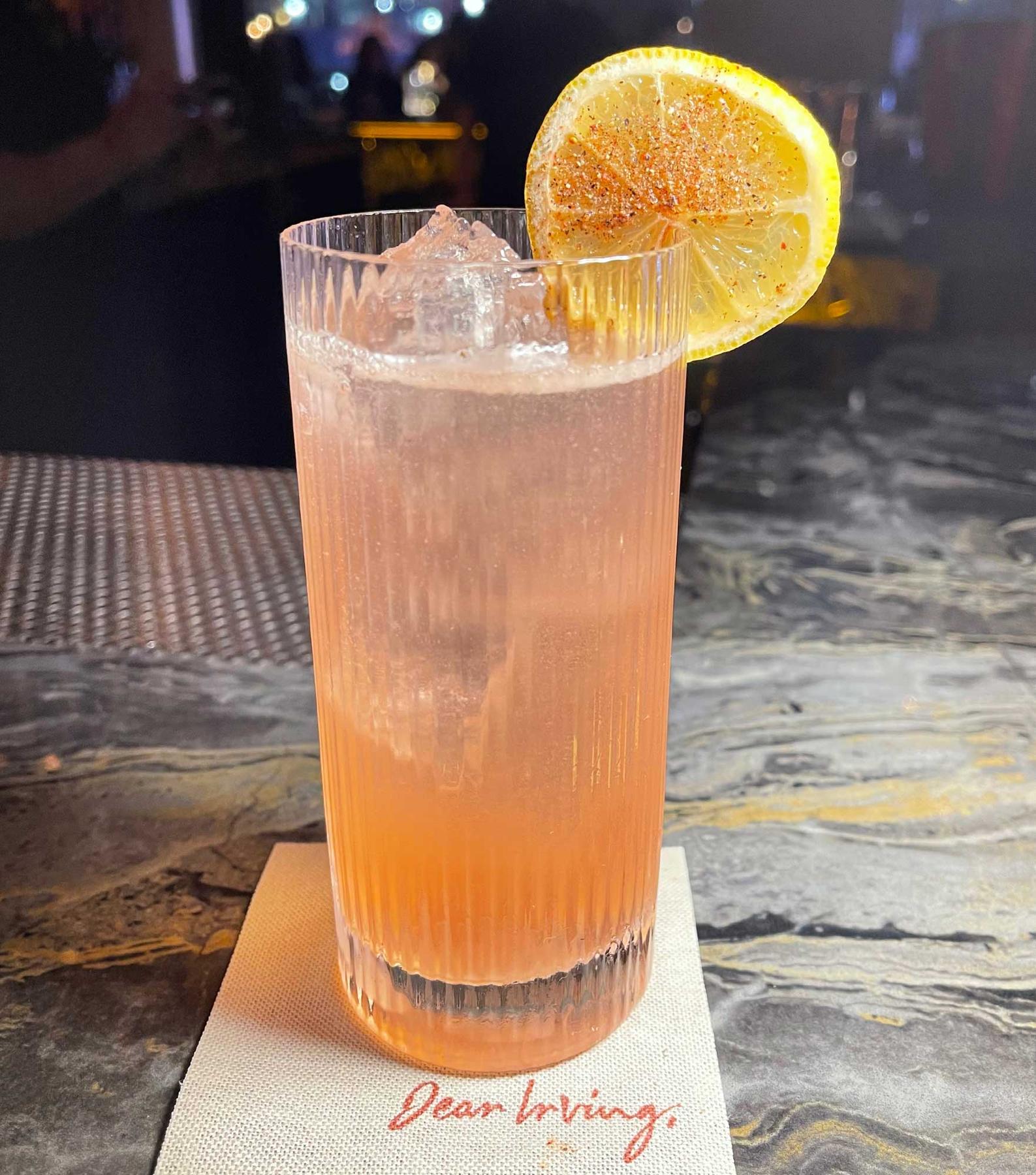 An example of the Fresa Suprema, the mixed drink (drink), by Benjamin Zapien at Dear Irving on Broadway, NYC, featuring seltzer, Chamberyzette, blanco tequila, fino sherry, lemon juice, vanilla syrup, seltzer, lemon wheel, strawberry, and peppercorn