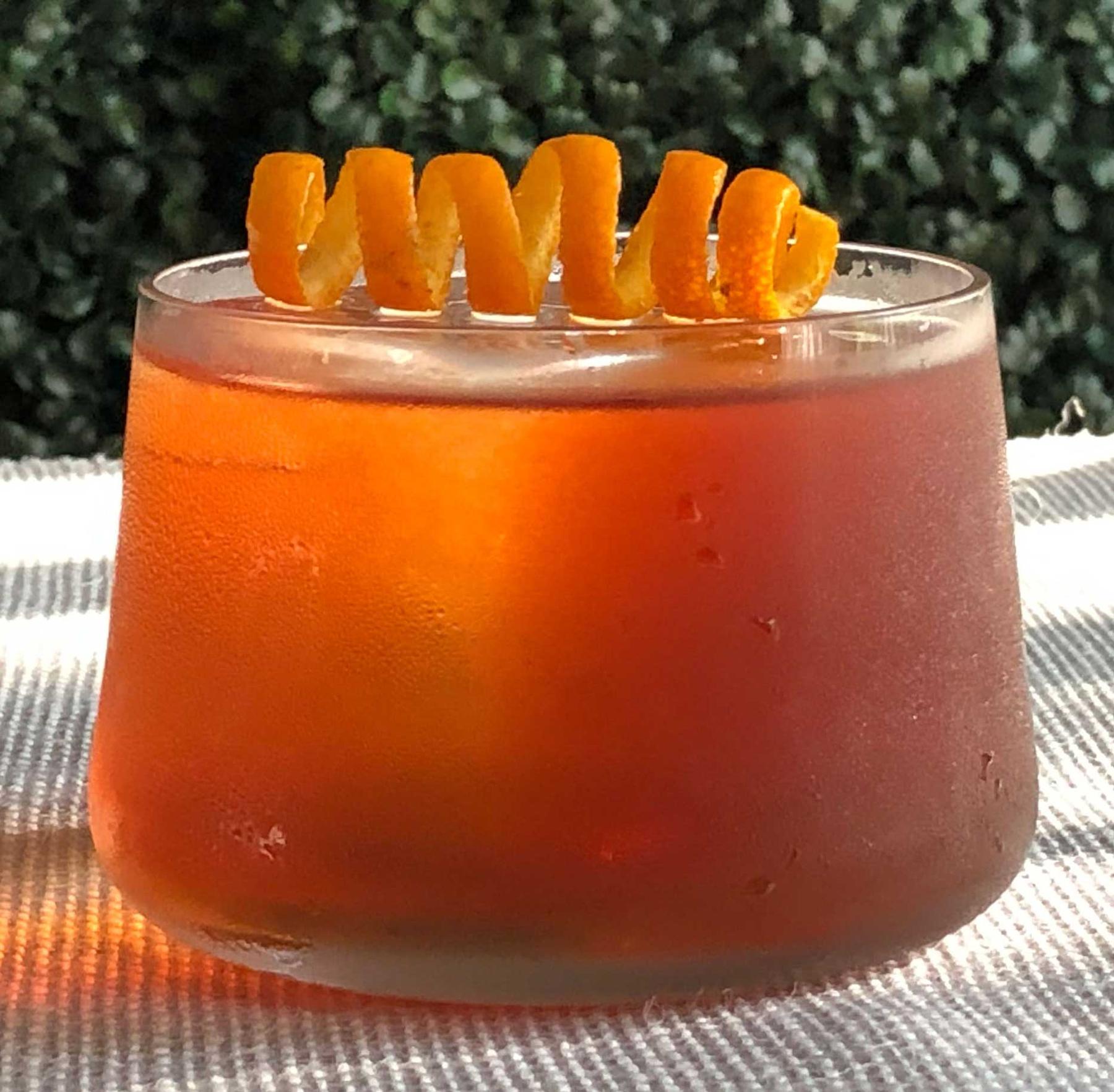An example of the Reunited, the mixed drink (drink) featuring rye whiskey, Comoz Blanc Vermouth de Chambèry, Aperitivo Cappelletti, Angostura bitters, and orange twist; photo by Lee Edwards