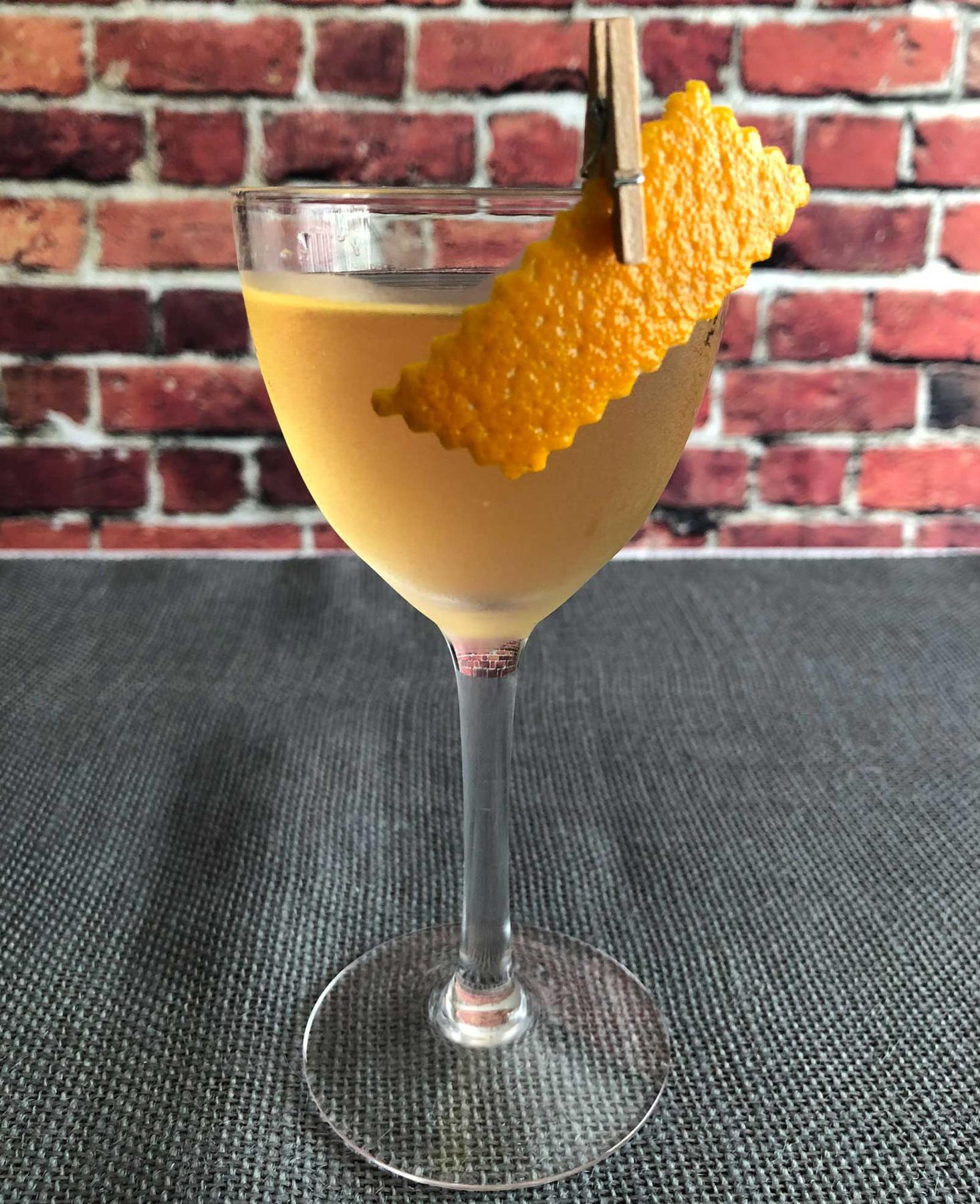 An example of the Rebirth of the Cool, the mixed drink (drink) featuring Mattei Cap Corse Blanc Quinquina, Purkhart Pear Williams Eau-de-Vie, orange bitters, and orange twist; photo by Lee Edwards
