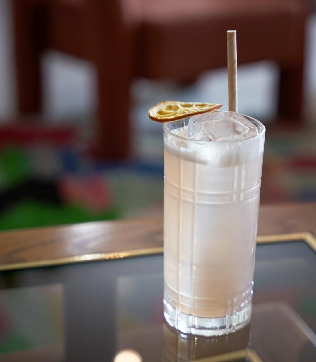 An example of the Passa Paloma, the mixed drink (drink), by Figidini, Providence, RI, featuring grapefruit soda, blanco tequila, Byrrh Grand Quinquina, and lemon twist; photo by Madison Young