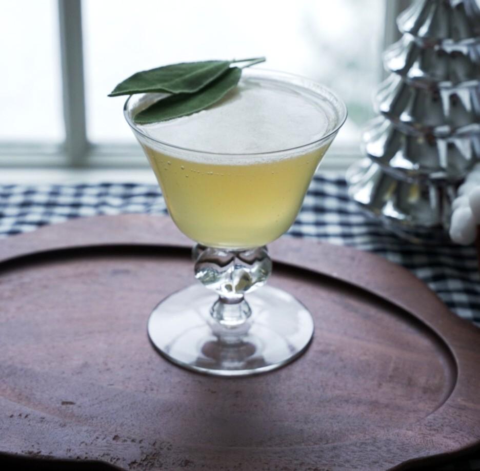 An example of the Lush Life, the mixed drink (drink), by Max Malouf, NYC, featuring rye whiskey, Meunier Génépy ‘Altitude’ Liqueur, John D. Taylor’s Velvet Falernum, lime juice, and sprig of sage; photo by Madison Young