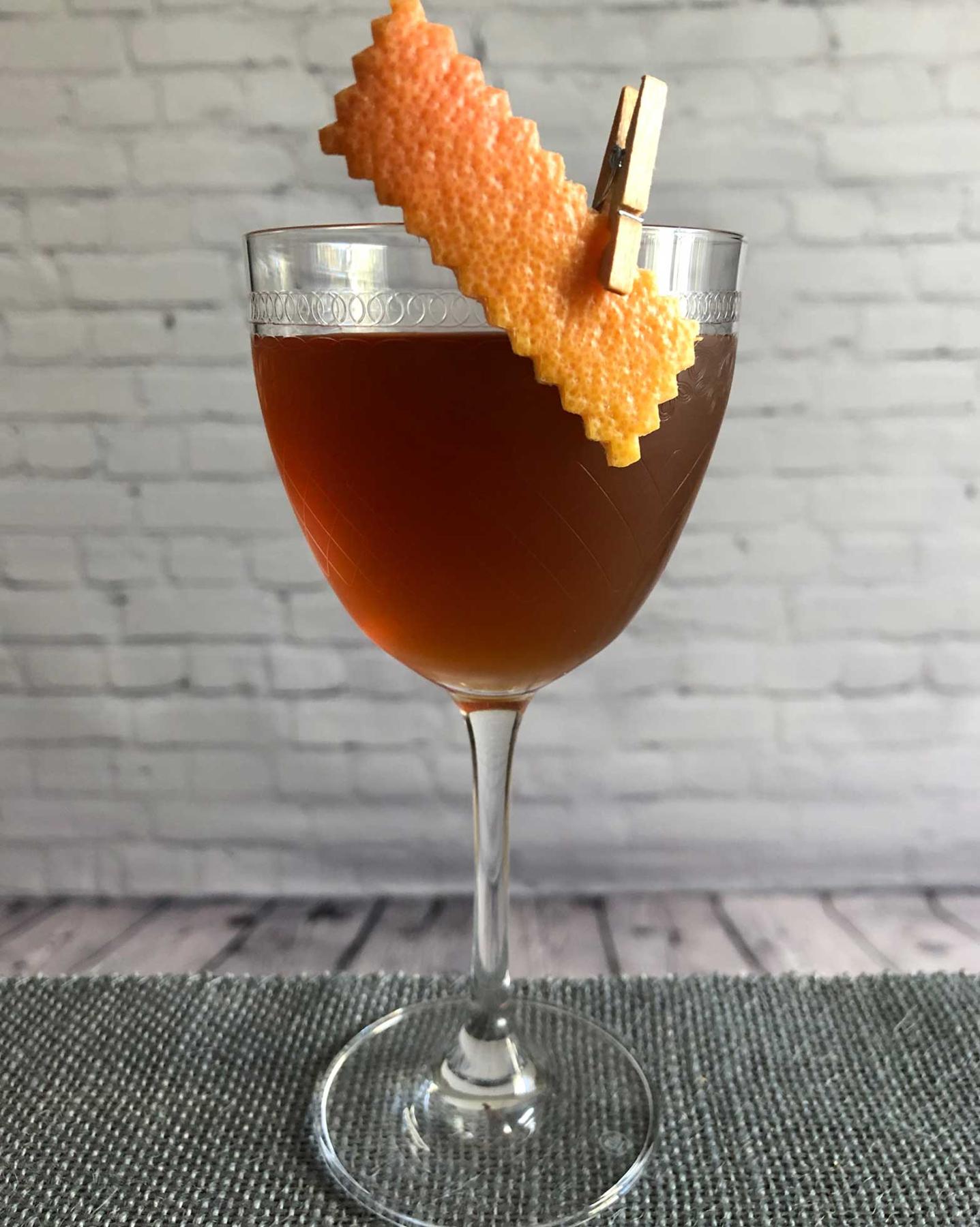 An example of the All the Difference, the mixed drink (drink) featuring rye whiskey, Mattei Cap Corse Rouge Quinquina, Amaro Sfumato Rabarbaro, and grapefruit twist; photo by Lee Edwards