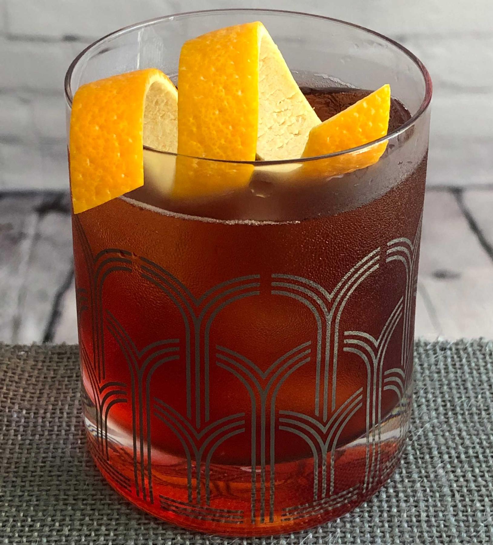 An example of the Chin-Chin, the mixed drink (drink) featuring Aperitivo Cappelletti, tonic water, Cocchi Barolo Chinato, and orange twist; photo by Lee Edwards