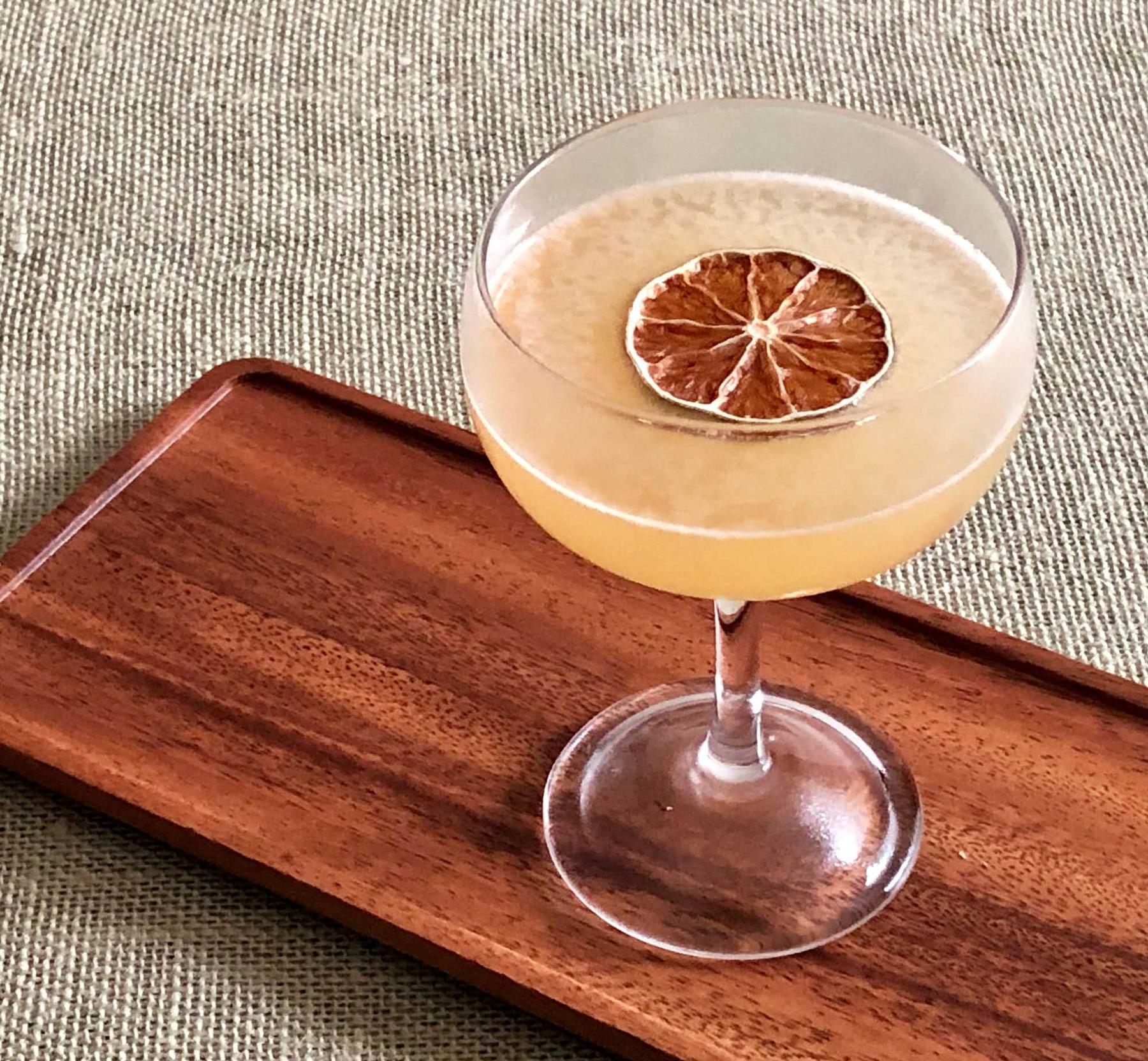 An example of the To The Sun, the mixed drink (drink) featuring Smith & Cross Traditional Jamaica Rum, lime juice, Rothman & Winter Orchard Apricot Liqueur, John D. Taylor’s Velvet Falernum, Angostura bitters, and lime wheel; photo by Lee Edwards