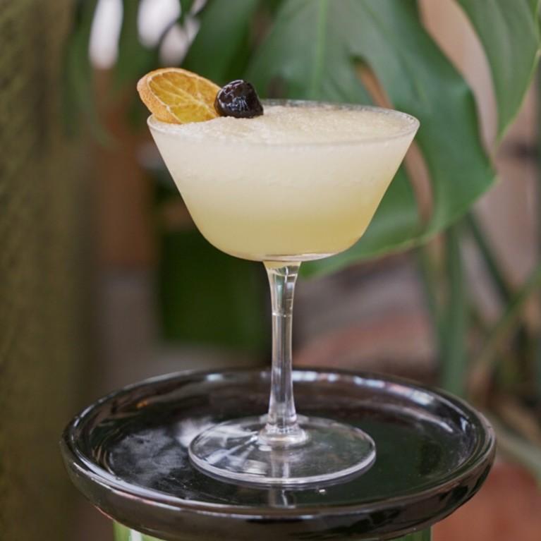 An example of the Saturn, the mixed drink (drink), by J. Galsini, featuring Hayman’s Royal Dock Navy Strength Gin, lemon juice, orgeat, passion fruit purée, John D. Taylor’s Velvet Falernum, crushed ice, and maraschino cherry; photo by Madison Young