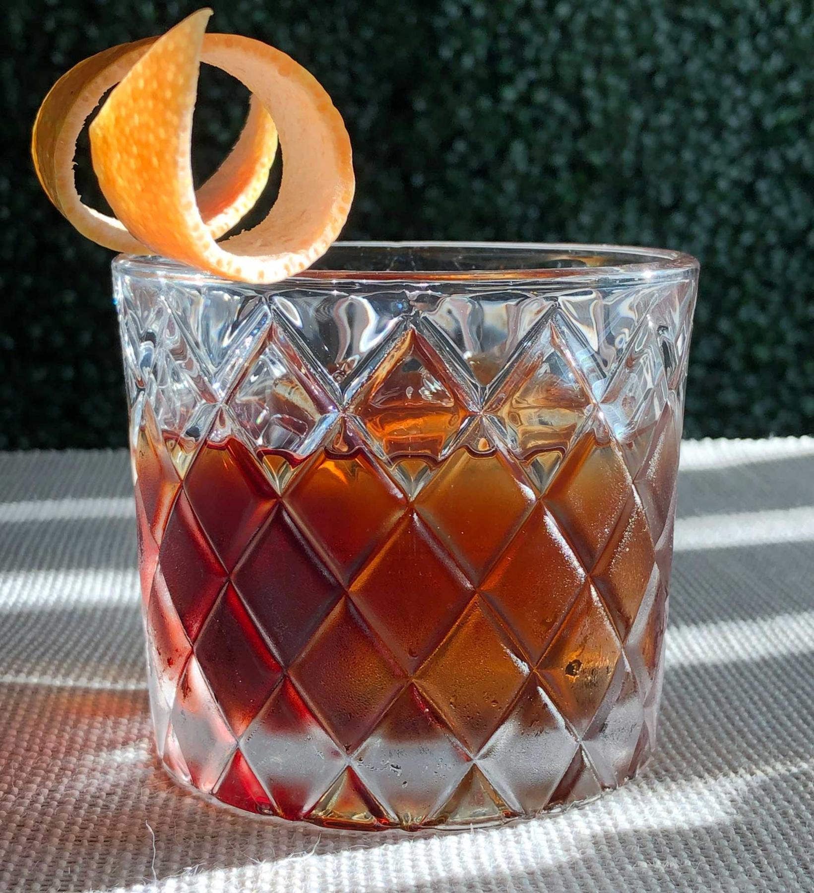 An example of the Quina-Quina, the mixed drink (drink) featuring Byrrh Grand Quinquina, Bonal Gentiane-Quina, soda water, and grapefruit twist; photo by Lee Edwards