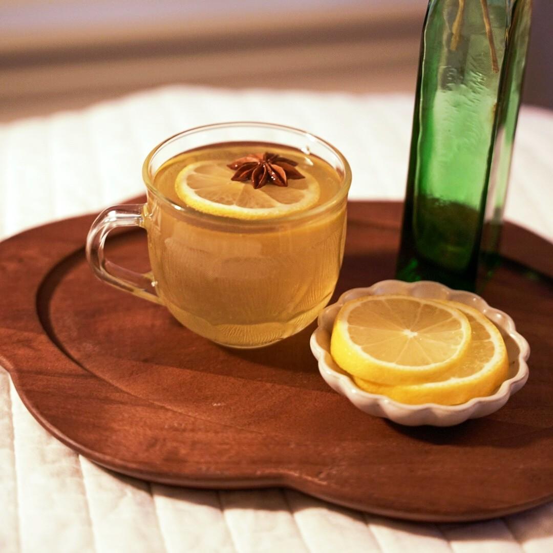 An example of the Aquavit Hot Toddy, the mixed drink (drink), by Jacob Grier, featuring hot water, aquavit, KRONAN Swedish Punsch, lemon juice, honey, star anise, and lemon twist; photo by Madison Young