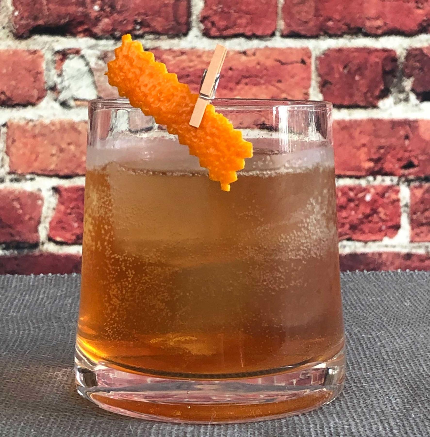 An example of the Cocconato Cooler, the mixed drink (drink) featuring soda water, Cocchi Vermouth di Torino ‘Storico’, Cocchi Americano Bianco, lemon juice, and orange twist; photo by Lee Edwards