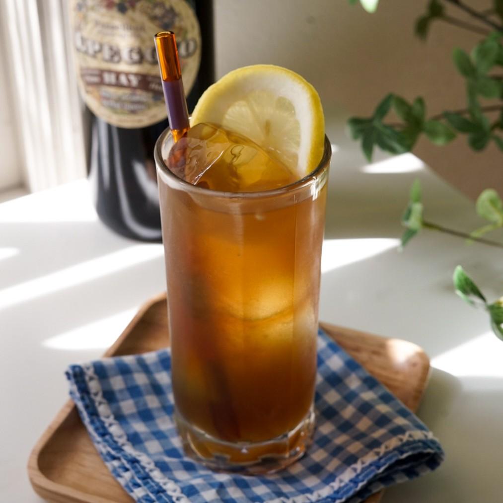 An example of the Purdy Birdie, the mixed drink (drink), by Jenn Hodges, The Case Room, Lockhart, TX, featuring black tea, Alpeggio Hay Liqueur, lemon juice, black tea, and lemon wheel; photo by Madison Young