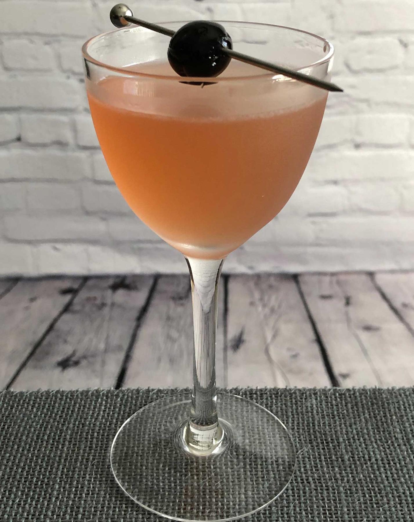 An example of the Her Alibi, the mixed drink (drink) featuring vodka, Rothman & Winter Orchard Cherry Liqueur, lime juice, orange-flavored liqueur, and maraschino cherry; photo by Lee Edwards
