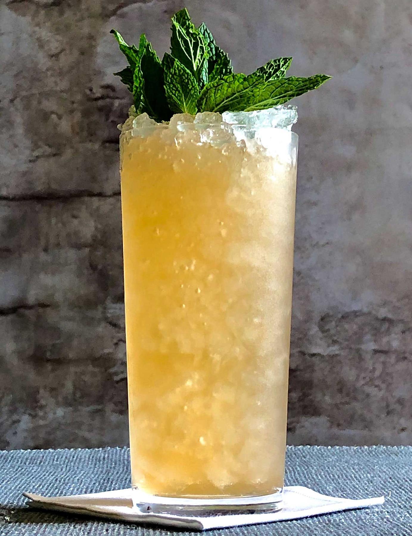 An example of the Velvet Buckaneer, the mixed drink (drink) featuring ginger beer, bourbon whiskey, John D. Taylor’s Velvet Falernum, St. Elizabeth Allspice Dram, lime juice, aromatic bitters, and mint; photo by Lee Edwards