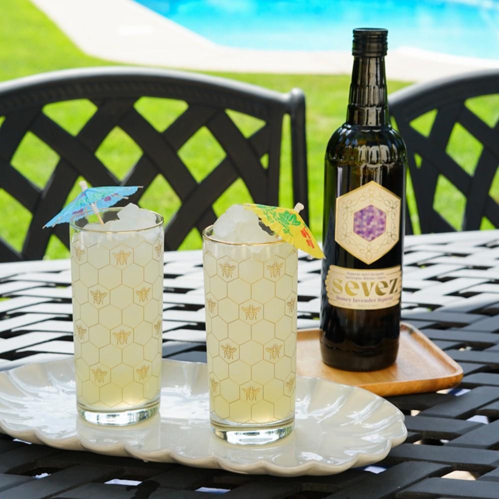 An example of the Honey Lavender Lemonade, the mixed drink (drink) featuring lemonade, Sevez Honey Lavender, and lemon twist