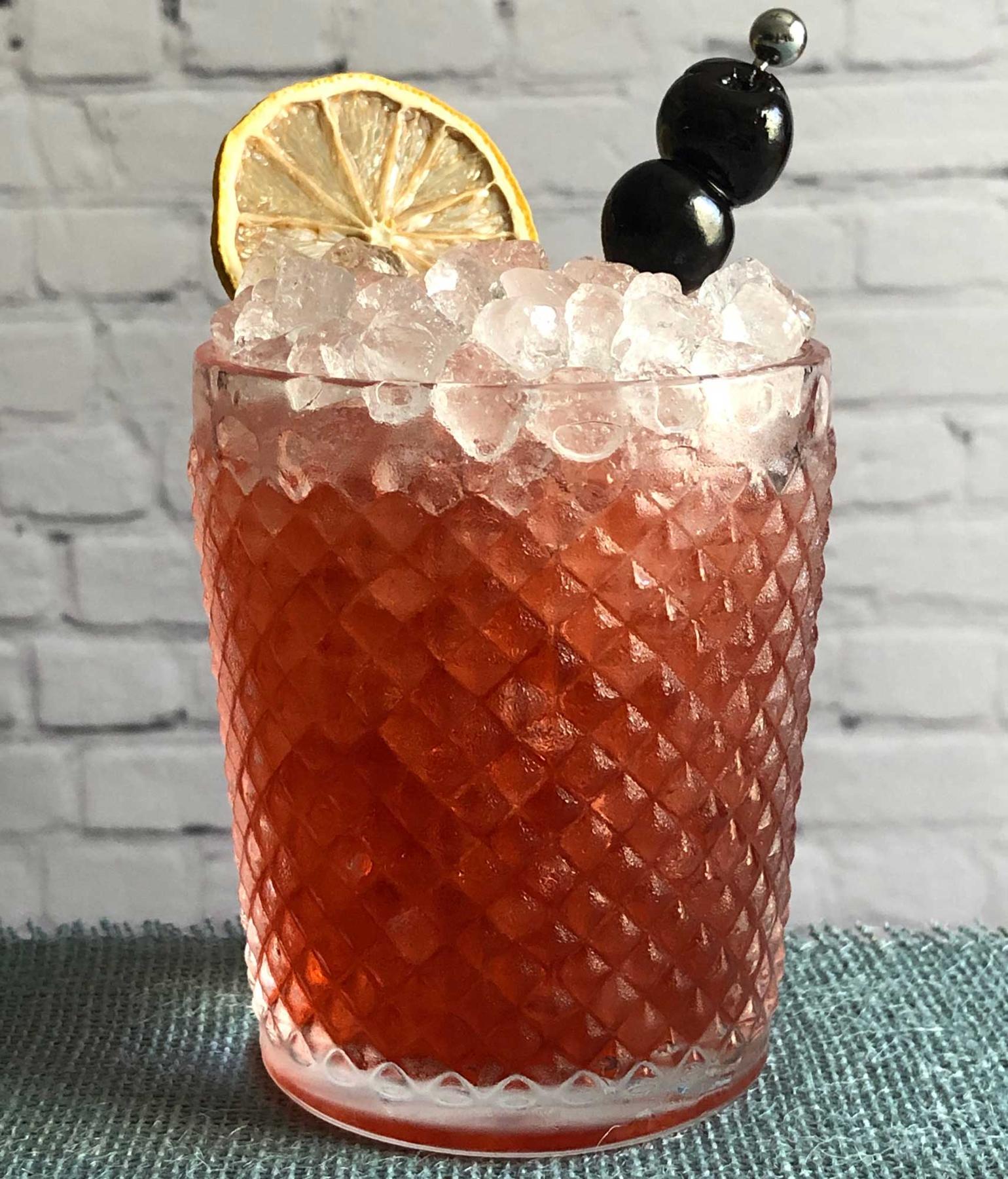 An example of the Cheerwine Swizzle, the mixed drink (drink), by David Burnette, South on Main, Little Rock, Arkansas, featuring Cheerwine, Dolin Génépy le Chamois Liqueur, and lemon juice; photo by Lee Edwards