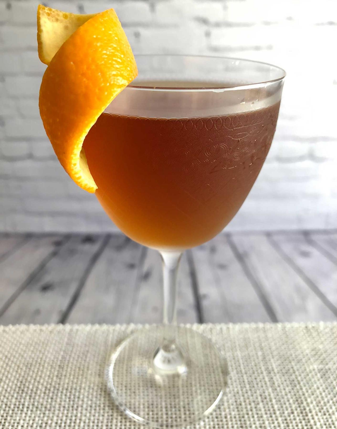 An example of the Palmetto No. 1, the mixed drink (drink) featuring Smith & Cross Traditional Jamaica Rum, Cocchi Vermouth di Torino ‘Storico’, orange bitters, and orange twist; photo by Lee Edwards