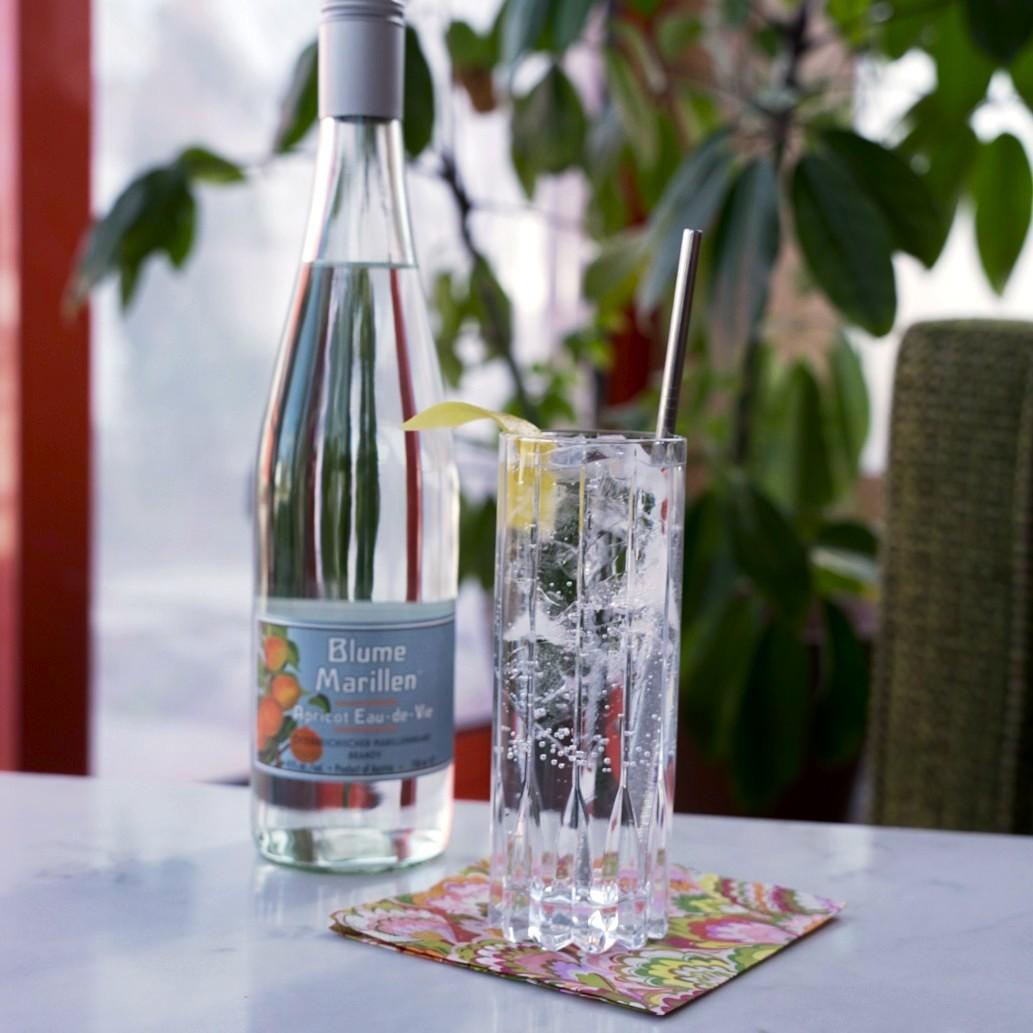 An example of the Blume in Highball, the mixed drink (drink) featuring soda water, Blume Marillen Apricot Eau-de-Vie, and lemon twist; photo by Madison Young