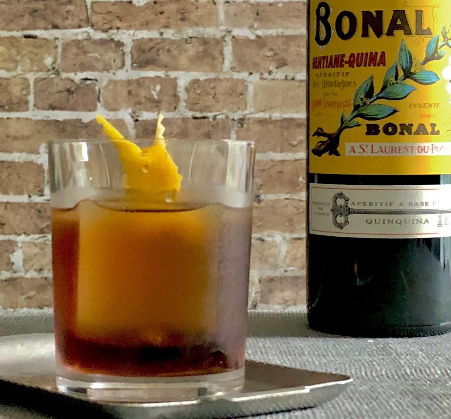 An example of the Tif & Tivo, the mixed drink (drink), by Rhiannon Enlil, New Orleans, featuring Bonal Gentiane-Quina, Cocchi Americano Bianco, and lemon twist; photo by Lee Edwards