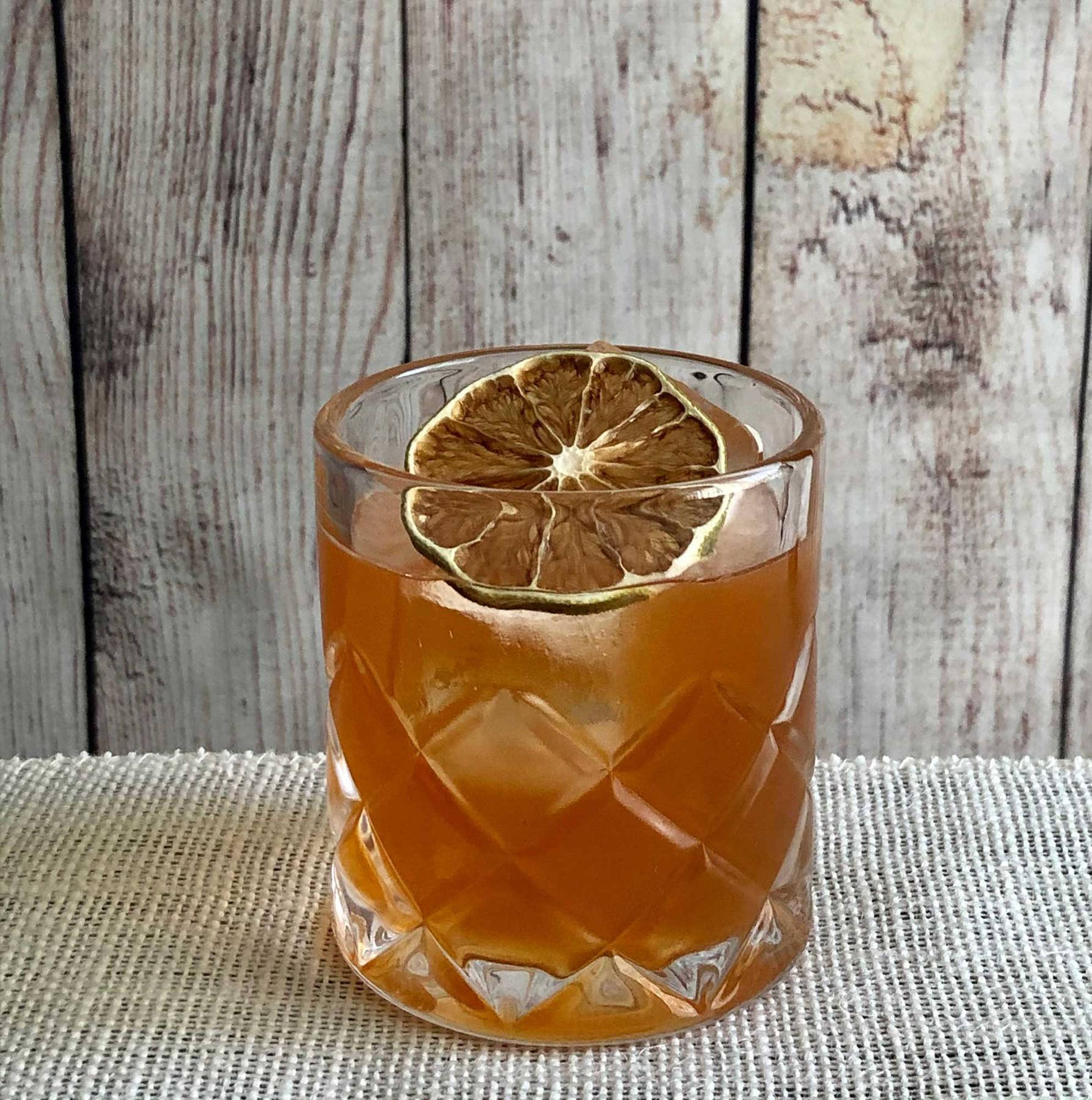 An example of the Bajan Legend, the mixed drink (drink) featuring brown barbados rum, John D. Taylor’s Velvet Falernum, Angostura bitters, and lime wheel; photo by Lee Edwards