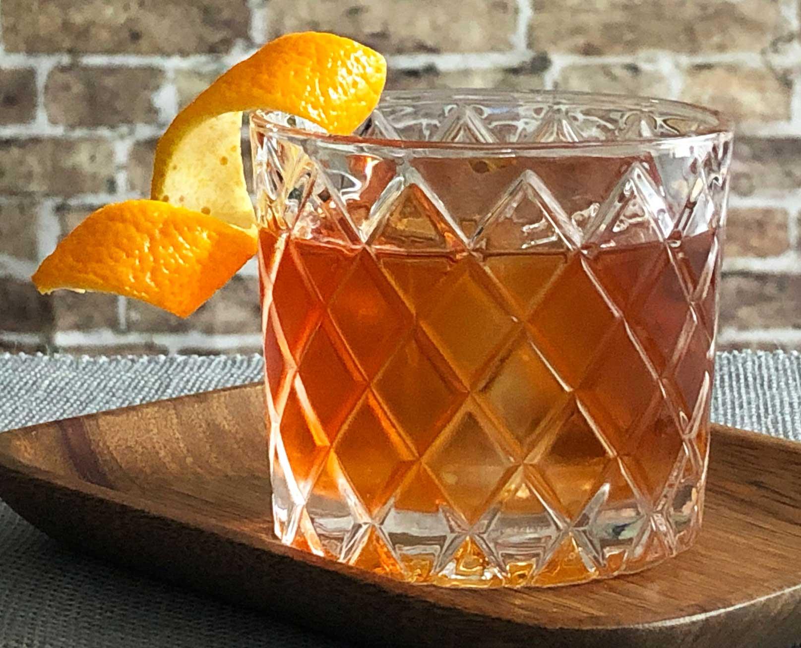 An example of the Rum Old Fashioned, the mixed drink (drink) featuring The Scarlet Ibis Trinidad Rum, Smith & Cross Traditional Jamaica Rum, raw sugar syrup, Angostura bitters, and orange twist; photo by Lee Edwards
