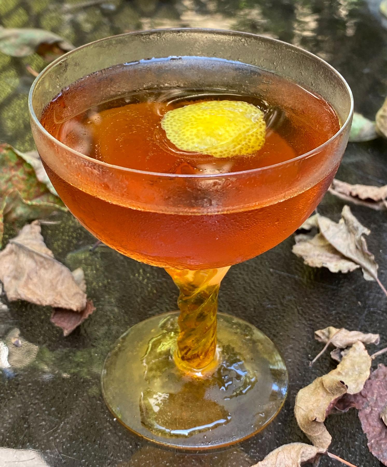 An example of the Harvest Cocktail, the mixed drink (drink) featuring apple brandy, Cardamaro Vino Amaro, Angostura bitters, and lemon twist; photo by Martin Doudoroff