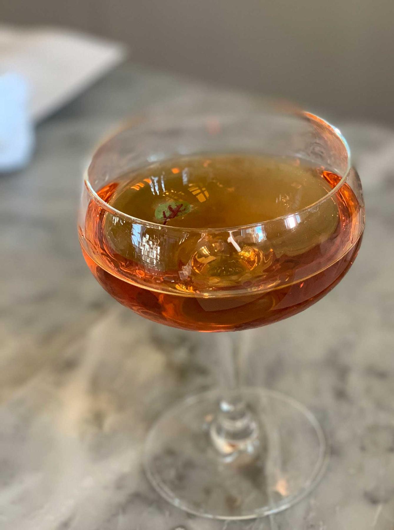 An example of the Into the Woods, the mixed drink (drink), by Lindsay Matteson, The Walrus and the Carpenter, Seattle, featuring Hayman’s London Dry Gin, Cocchi Americano Bianco, Zirbenz Stone Pine Liqueur of the Alps, Amaro Alta Verde, and Scrappy’s Aromatic Bitters