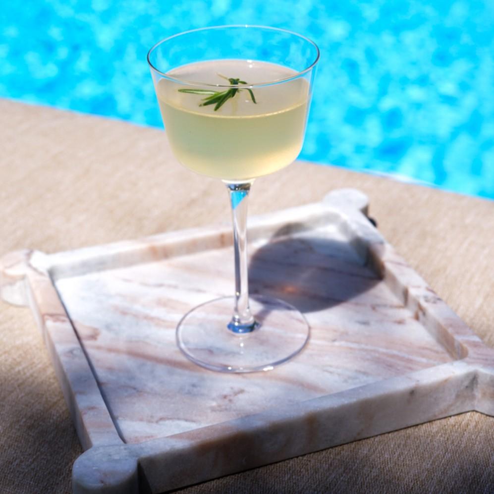 An example of the Bucket List, the mixed drink (drink), by Difford's Guide, featuring vodka, Sevez Honey Lavender, Meunier Génépy ‘Altitude’ Liqueur, lemon juice, honey syrup, and sprig of rosemary