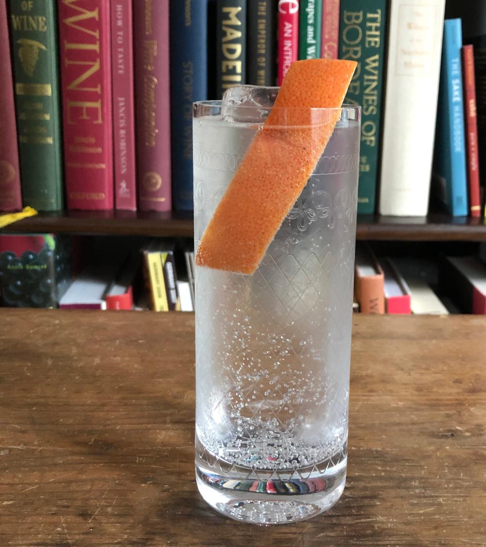 An example of the Bark and Bite, the mixed drink (drink) featuring tonic water, Batavia Arrack van Oosten, Dolin Génépy le Chamois Liqueur, and grapefruit twist; photo by Lee Edwards