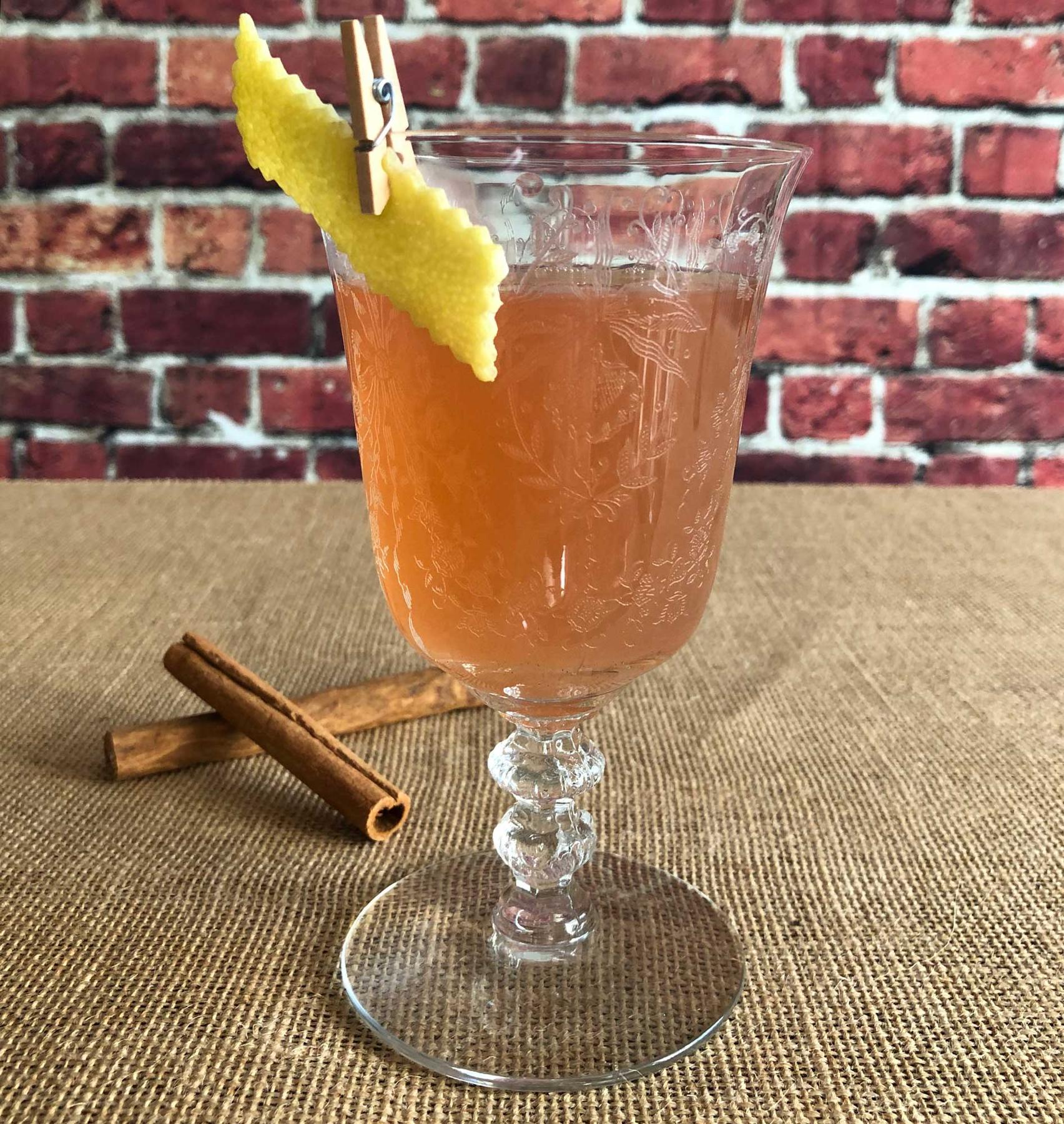 An example of the Real Thing Toddy, the mixed drink (drink) featuring hot water, The Scarlet Ibis Trinidad Rum, Zirbenz Stone Pine Liqueur of the Alps, lemon juice, sugar, cinnamon stick, and lemon twist; photo by Lee Edwards