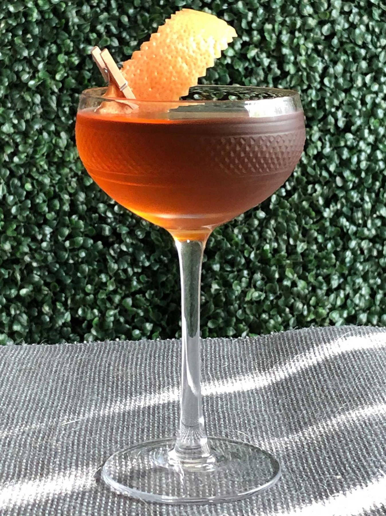 An example of the Diamond in the Rough, the mixed drink (drink) featuring Hayman’s Old Tom Gin, Bonal Gentiane-Quina, Amaro Alta Verde, orange bitters, and grapefruit twist; photo by Lee Edwards