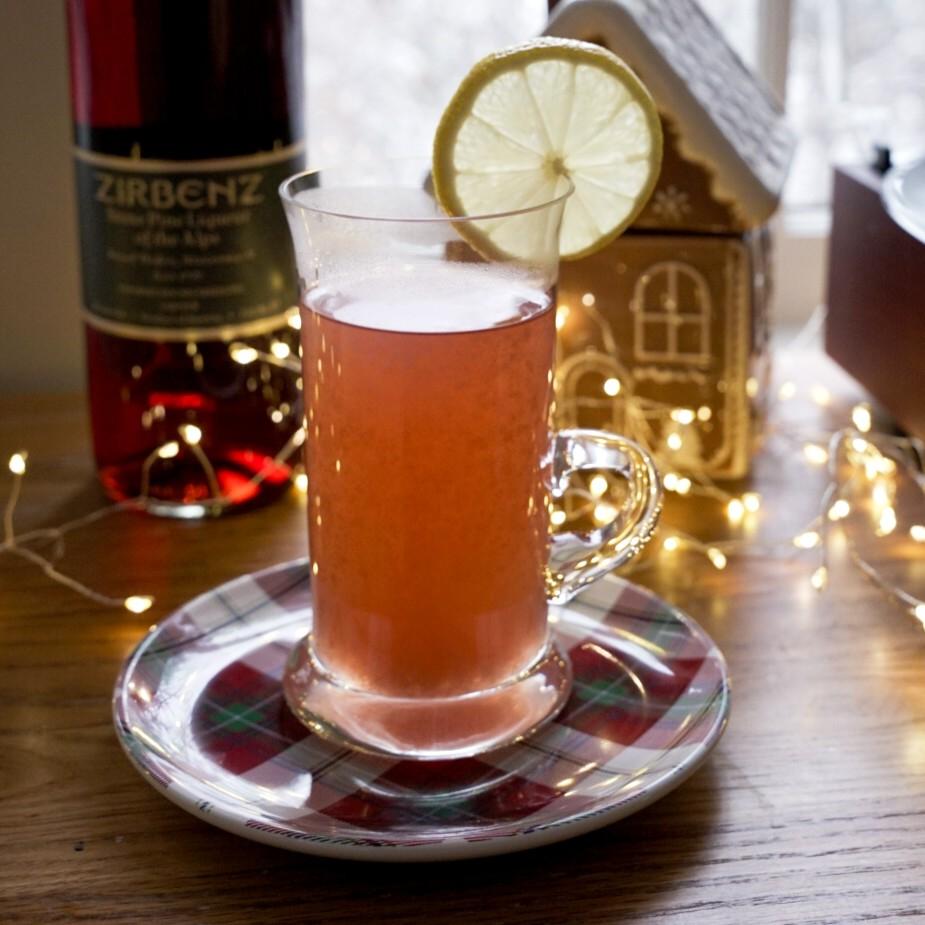 An example of the Sierra Madre Occidental, the mixed drink (drink) featuring hot water, añejo tequila, Zirbenz Stone Pine Liqueur of the Alps, honey syrup, lemon juice, and lemon wheel; photo by Madison Young