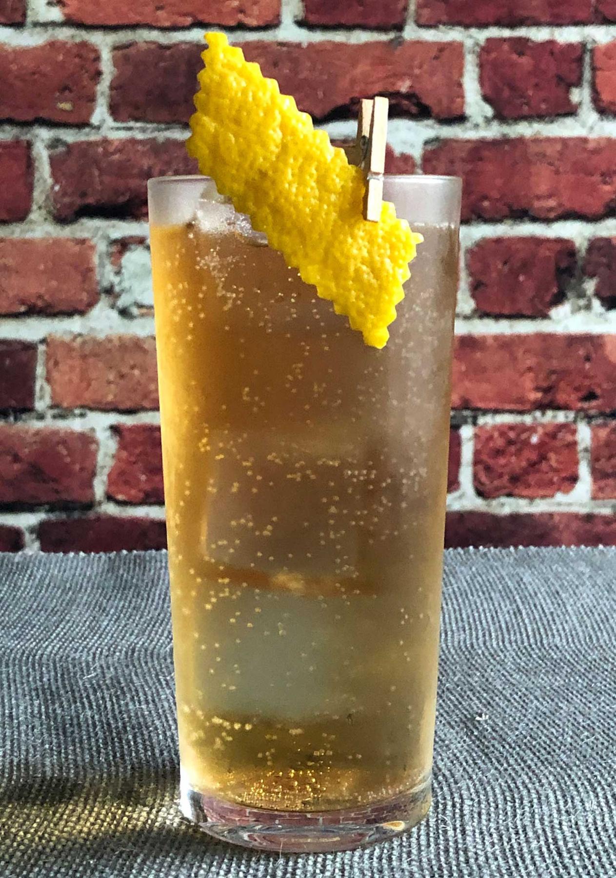An example of the Digging in the Dirt, the mixed drink (drink) featuring tonic water, Salers Gentian Apéritif, Cardamaro Vino Amaro, and lemon twist; photo by Lee Edwards