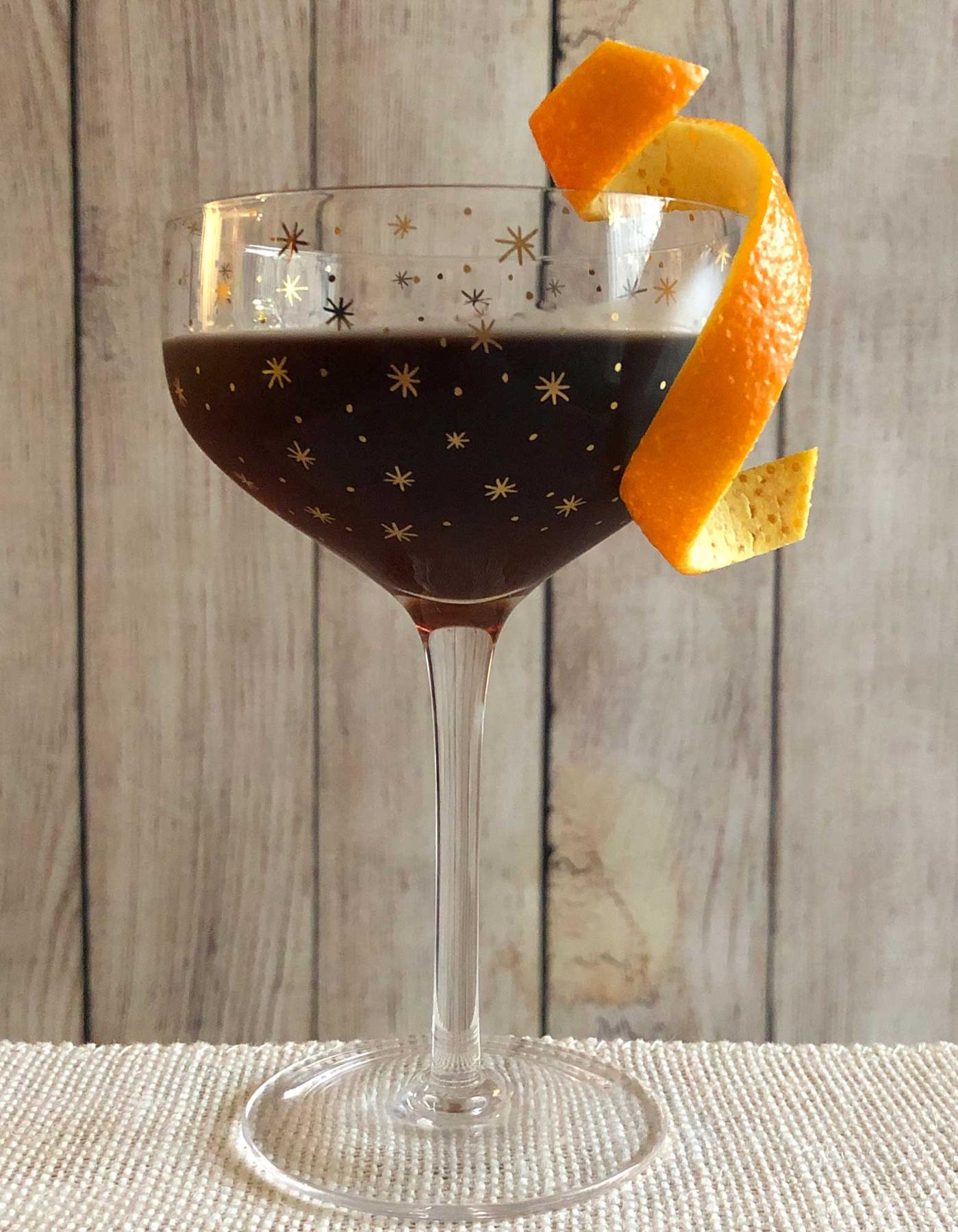 An example of the El Poco Loco, the mixed drink (drink) featuring Hayman’s Old Tom Gin, Dolin Rouge Vermouth de Chambéry, Nux Alpina Walnut Liqueur, and orange twist; photo by Lee Edwards