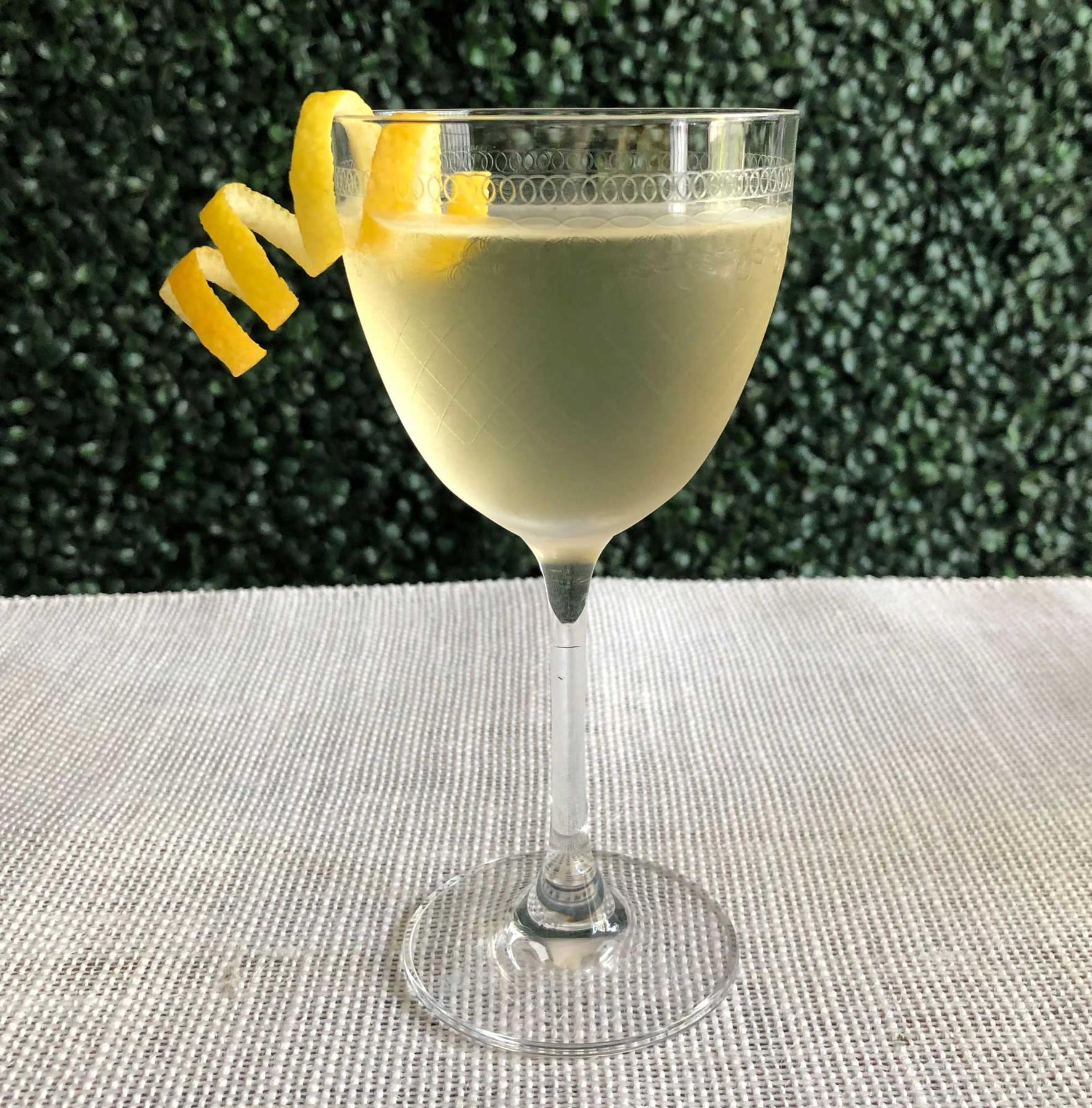 An example of the Parfait Parfait, the mixed drink (drink), by Kelly O’Hare, Austin, TX, featuring Hayman’s London Dry Gin, Comoz Blanc Vermouth de Chambèry, Mattei Cap Corse Blanc Quinquina, and lemon twist; photo by Lee Edwards