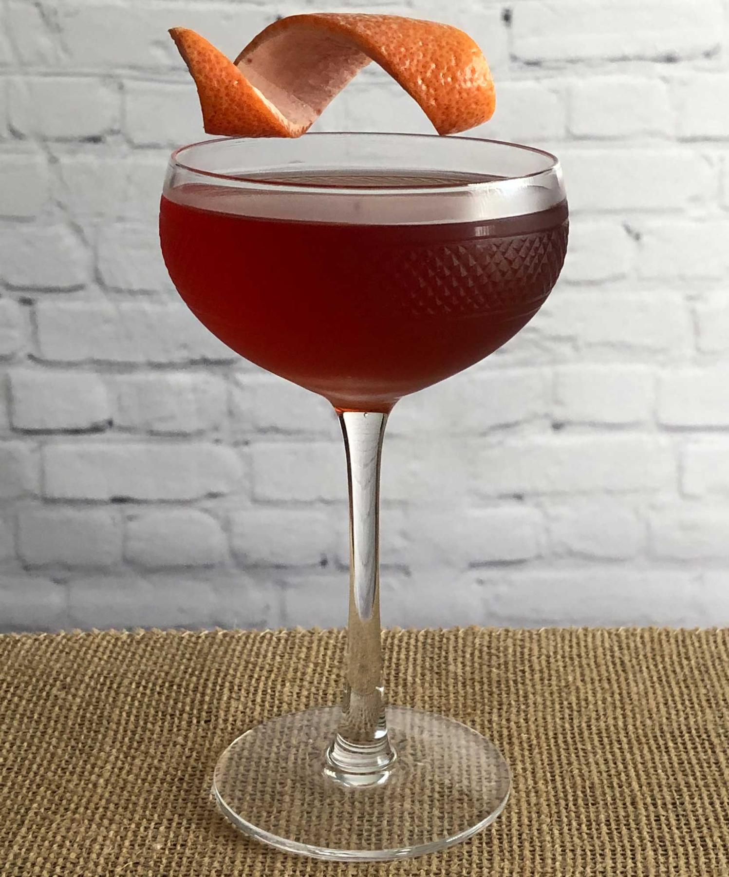 An example of the Bobby Byrrhns, the mixed drink (drink) featuring scotch whisky, Byrrh Grand Quinquina, Bénédictine, orange bitters, Angostura bitters, and grapefruit twist; photo by Lee Edwards