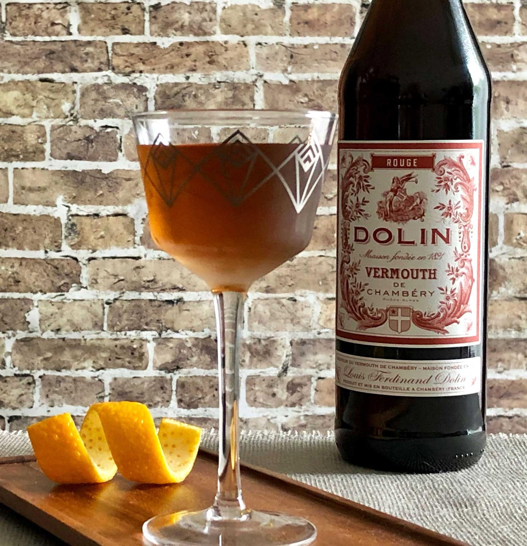 An example of the Aphrodite No. 2, the mixed drink (drink) featuring Matifoc Rancio Sec, Timbal Vermut de Reus Sweet Red, Angostura bitters, and orange twist; photo by Lee Edwards