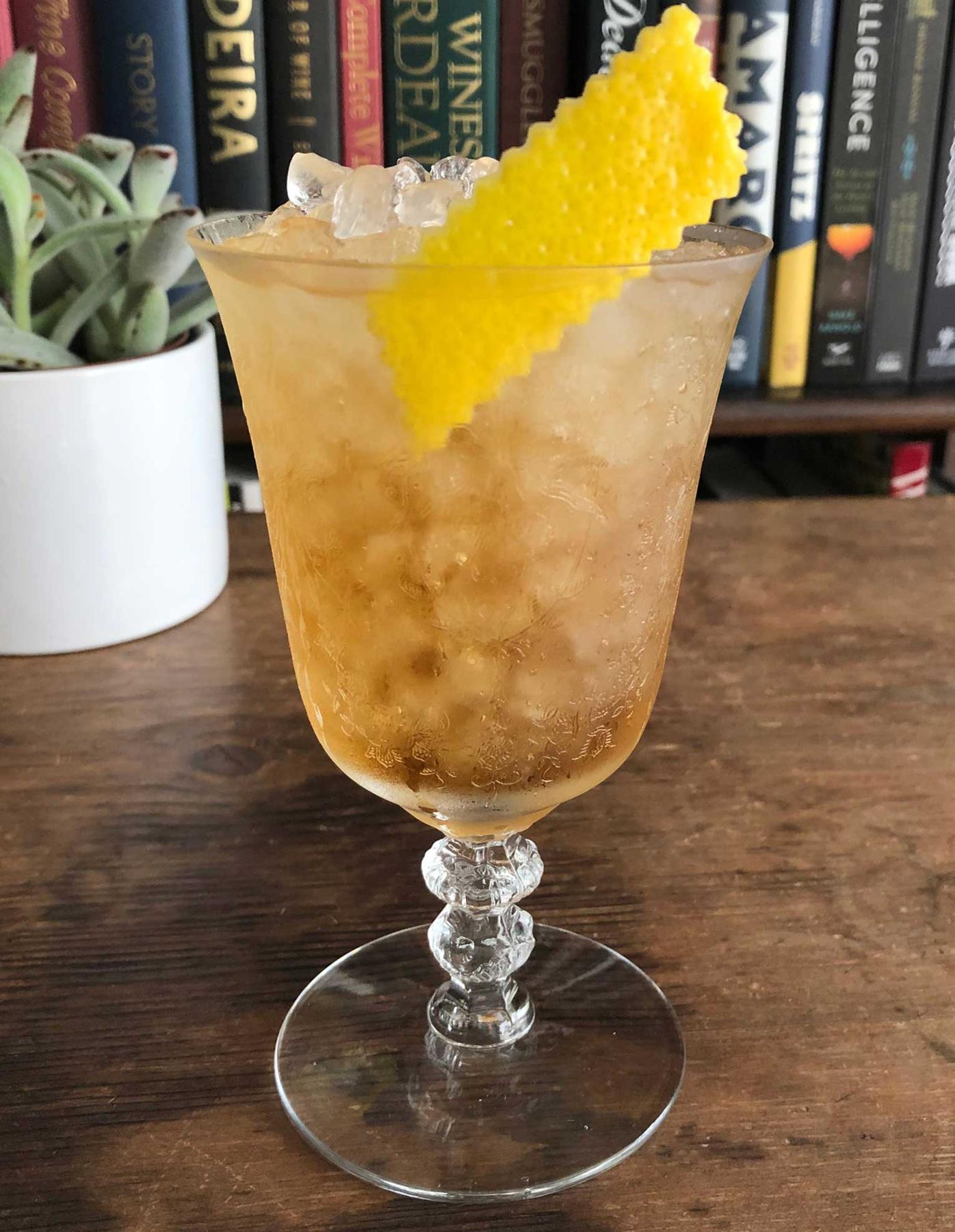 An example of the Stem to Petal, the mixed drink (drink) featuring Bonal Gentiane-Quina, Cocchi Asti DOCG, and lemon twist; photo by Lee Edwards