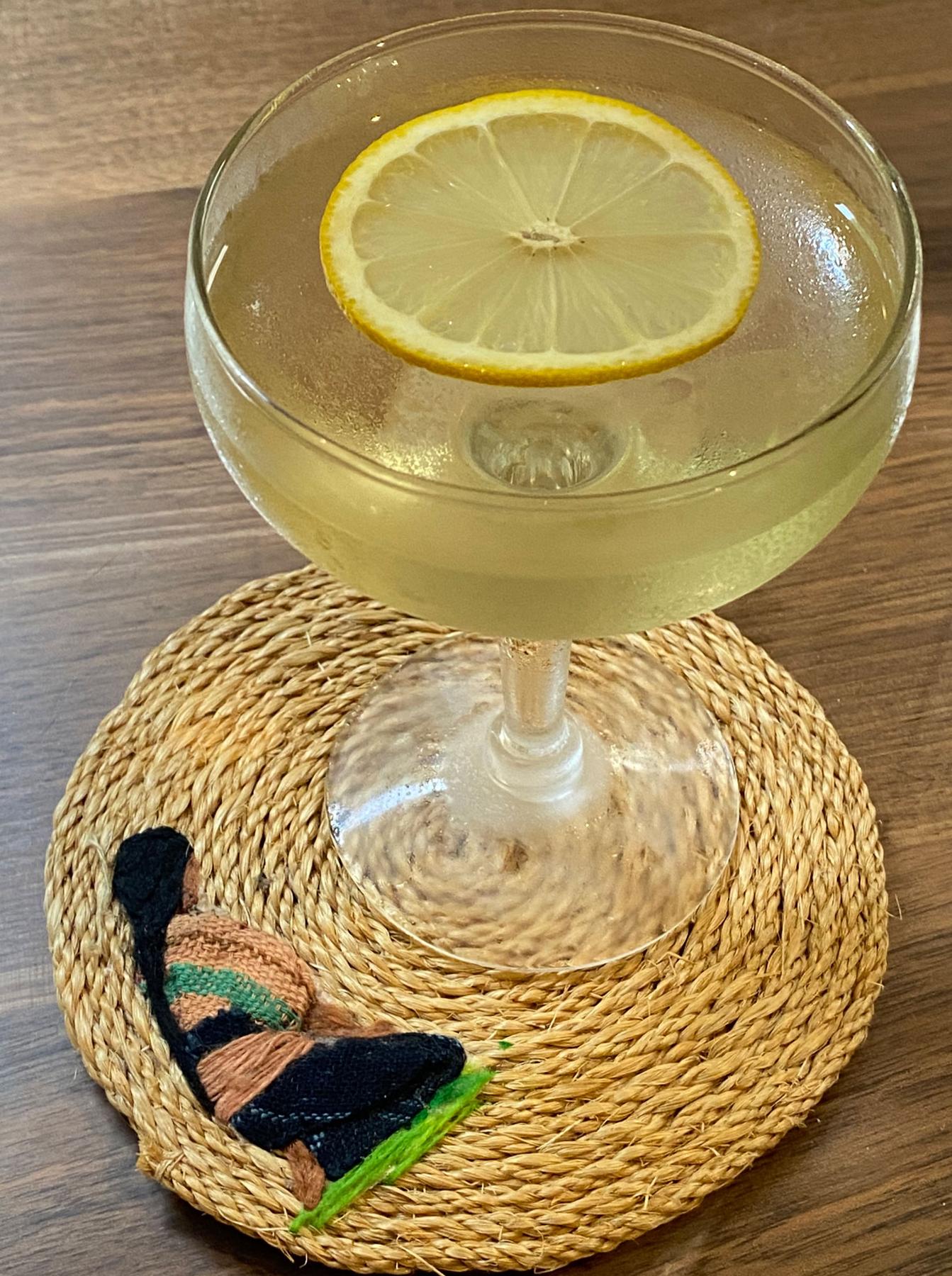 An example of the Adelita, the mixed drink (drink), by Carrie Cole, Hawthorne Bar, Boston, featuring reposado tequila, Dolin Blanc Vermouth de Chambéry, Cocchi Americano Bianco, Rothman & Winter Crème de Violette, and lemon wheel; photo by Martin Doudoroff