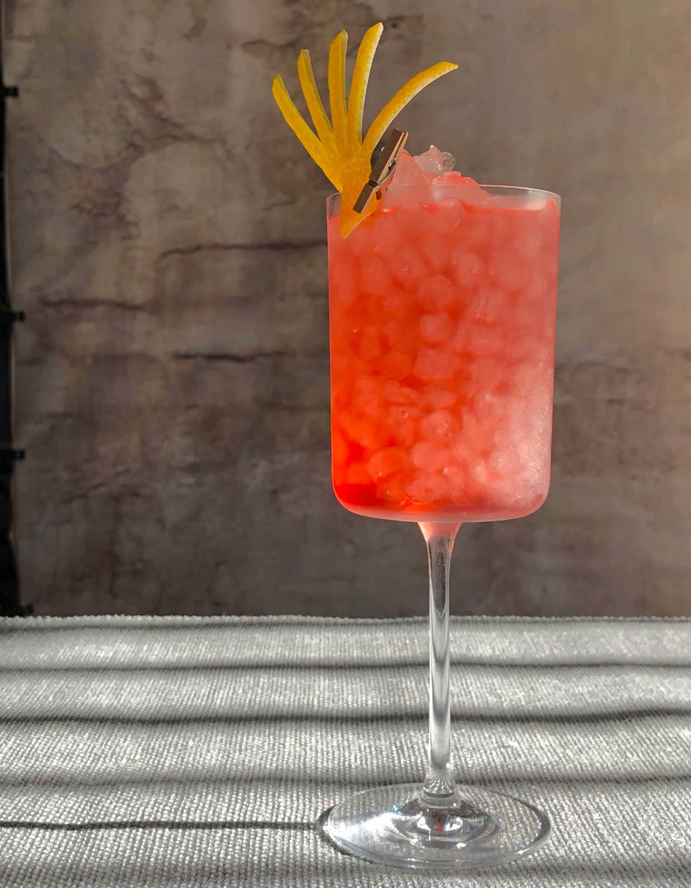 An example of the Santa Rosa Highball, the mixed drink (drink) featuring grapefruit soda, Cocchi Americano Rosa, blanco tequila, and lemon twist; photo by Lee Edwards