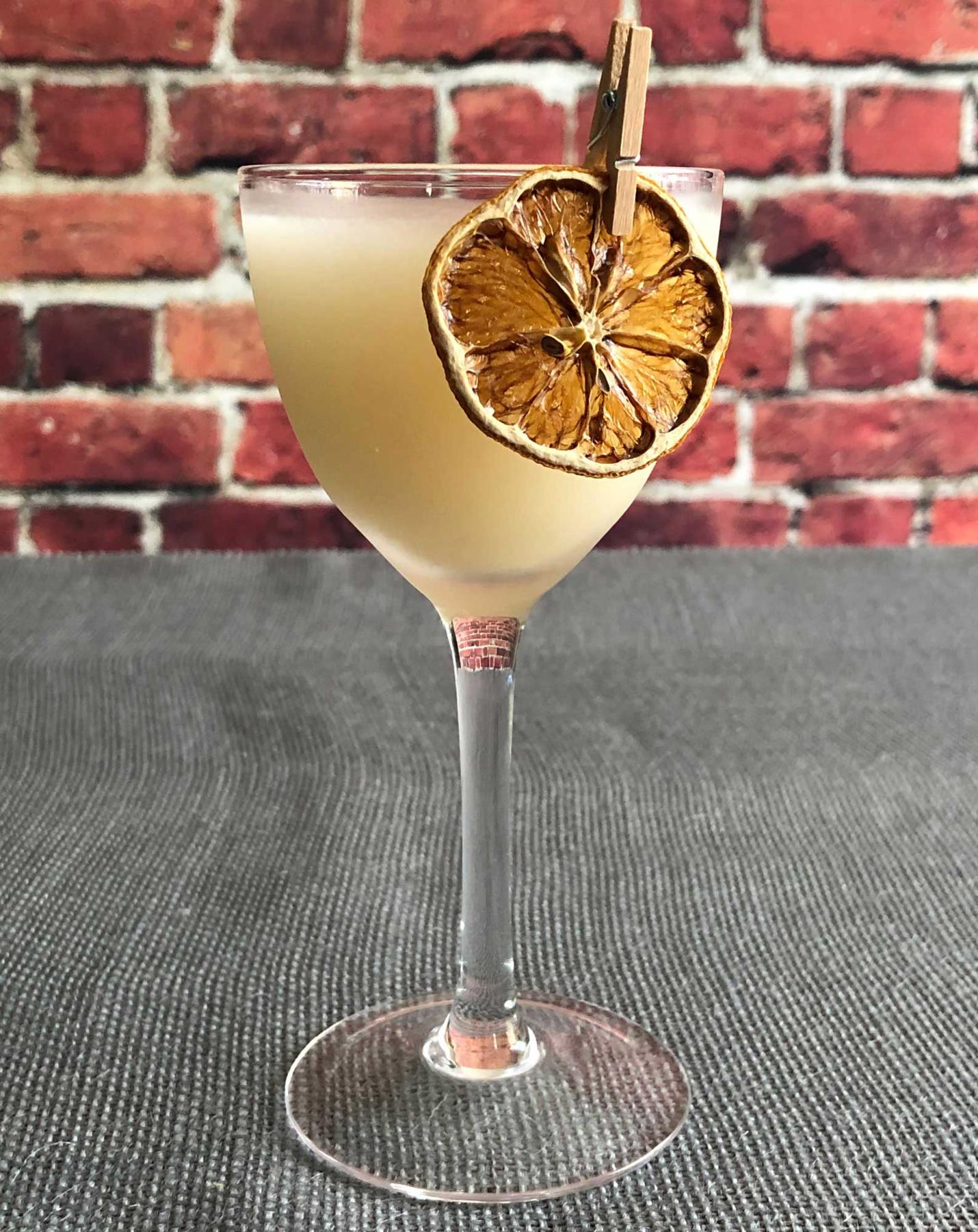 An example of the Royal Hawaiian, the mixed drink (drink) featuring Hayman’s Royal Dock Navy Strength Gin, pineapple juice, orgeat, lemon juice, and pineapple wedge; photo by Lee Edwards