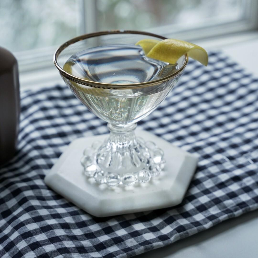 An example of the Elder Statesman, the mixed drink (drink), Variation on “Statesman,” Erick Castro, 2008, featuring Hayman’s London Dry Gin, Rothman & Winter Orchard Pear Liqueur, Dolin Génépy le Chamois Liqueur, orange bitters, and lemon twist; photo by Madison Young