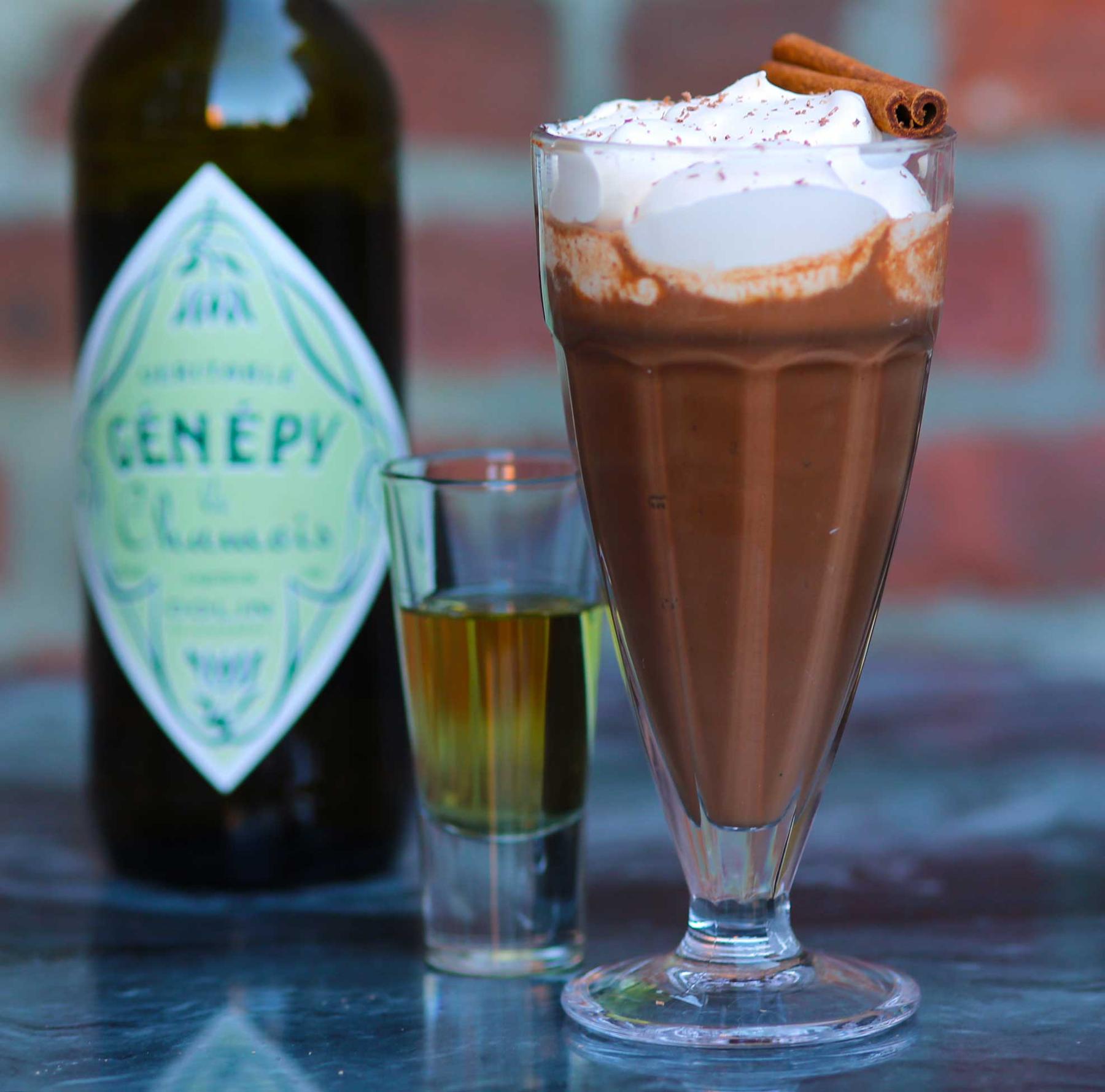 An example of the Génépy Chaud, the mixed drink (drink) featuring drinking chocolate, Dolin Génépy le Chamois Liqueur, and nux alpina whipped cream; photo by Lauren Clark