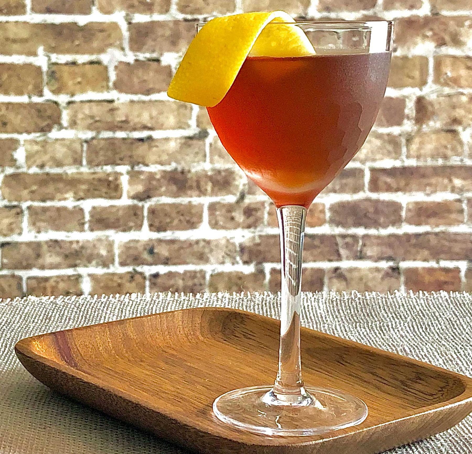 An example of the Fort Point, the mixed drink (drink), by Erik Adkins, Heaven’s Dog, San Francisco, featuring rye whiskey, Cocchi Barolo Chinato, Rothman & Winter Orchard Apricot Liqueur, and lemon twist; photo by Lee Edwards
