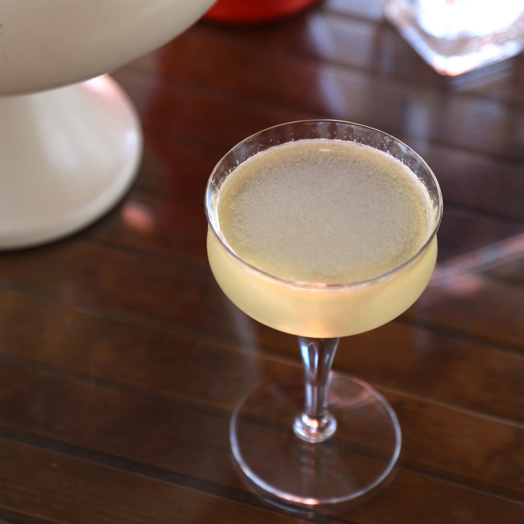 An example of the London Hollering, the mixed drink (drink), by Based on original cocktail by Chris Jepson, featuring london dry gin, Etter Quince, amontillado, lemon, and lemon twist; photo by Megan Heinowski