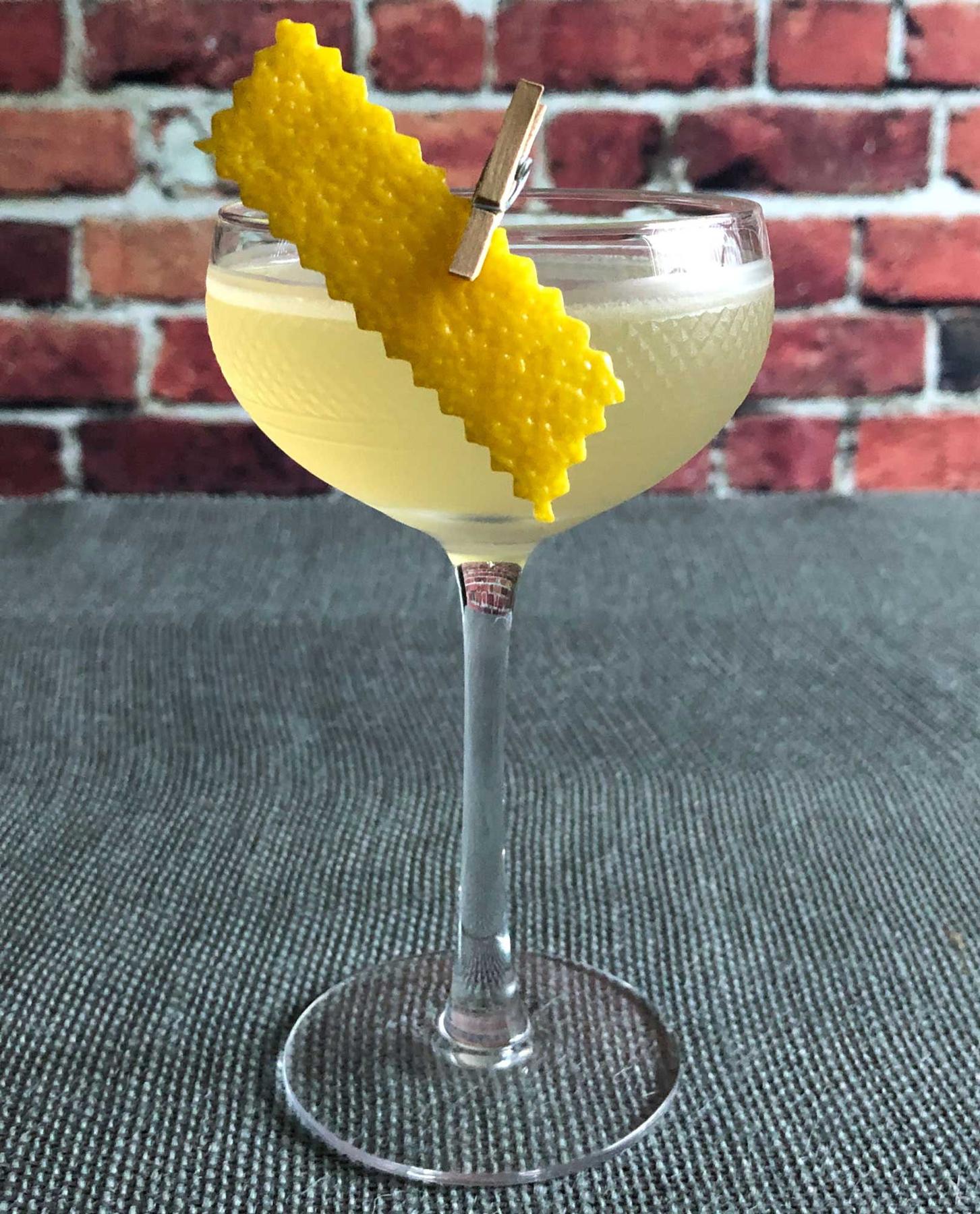 An example of the Her Word, the mixed drink (drink) featuring blanco tequila, Rothman & Winter Orchard Peach Liqueur, Cocchi Americano Bianco, lemon juice, and lemon twist; photo by Lee Edwards