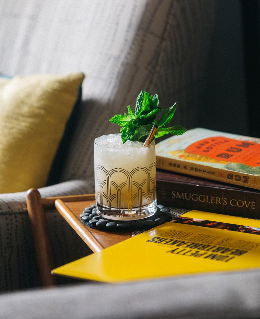An example of the Mai Tai, the mixed drink (drink) featuring Smith & Cross Traditional Jamaica Rum, The Scarlet Ibis Trinidad Rum, orgeat, lime juice, curaçao, and sprig of mint; photo by S. Kallstrand