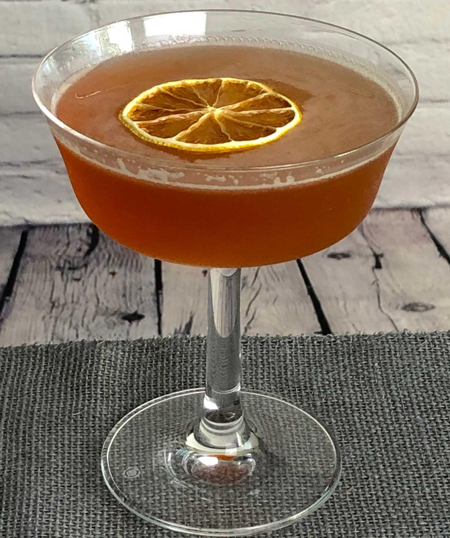 An example of the Hi-Hat Cocktail, the mixed drink (drink), variation of a drink from David Embury, The Fine Art of Mixing Drinks, featuring rye whiskey, Rothman & Winter Orchard Cherry Liqueur, lemon juice, and lemon twist; photo by Lee Edwards