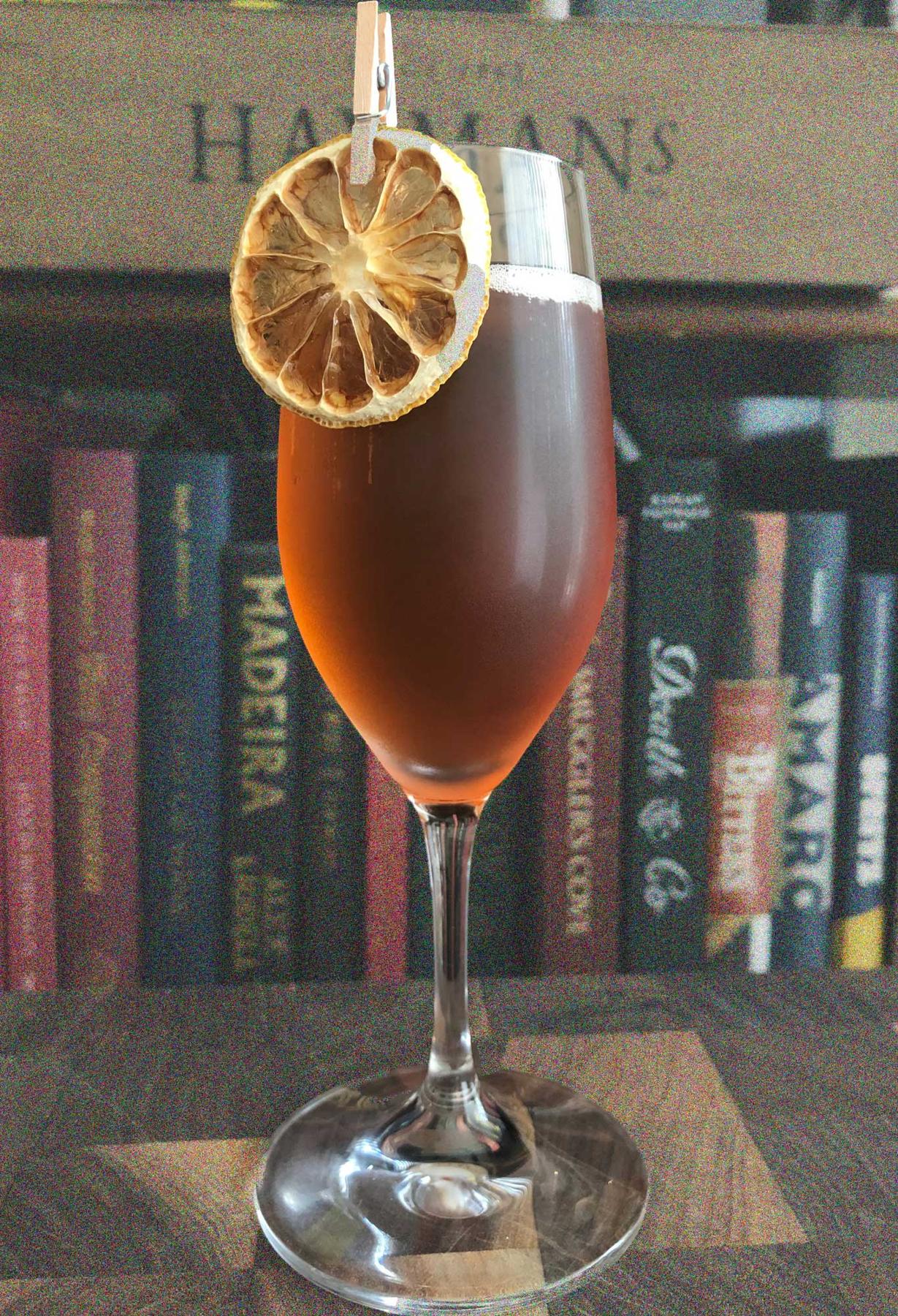 An example of the Merry Berries, the mixed drink (drink) featuring sparkling wine, Hayman’s Sloe Gin, Pasubio Vino Amaro, sparkling wine, and grapefruit twist; photo by Lee Edwards